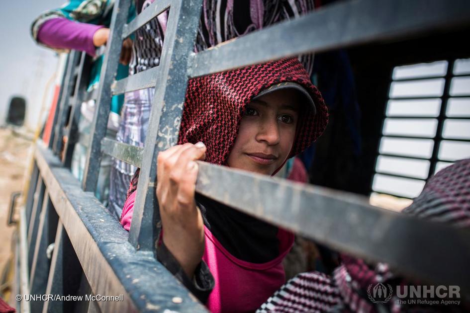 After a brief opportunity to eat some lunch Manar, 13, sits in a truck that will take her to work a second shift in a nearby potato field, in Fayda tented settlement, Bekaa Valley, Lebanon. 