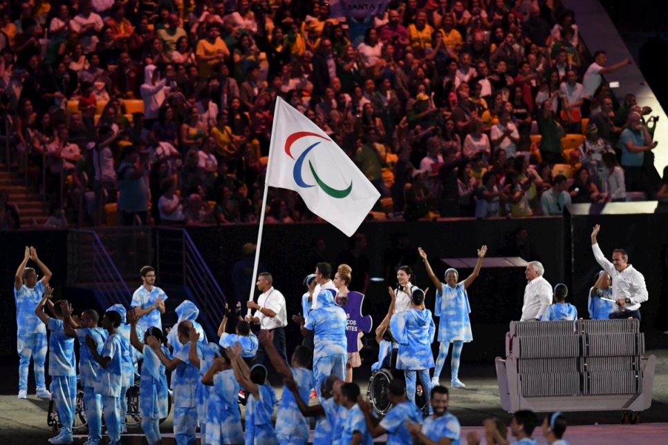 Syrian Swimmer Ibrahim Al-Hussein leads the first-ever Independent Paralympic Athletes Team at the Opening Ceremony of the 2016 Paralympic Games in Rio de Janeiro. © UNHCR/Benjamin Loyseau