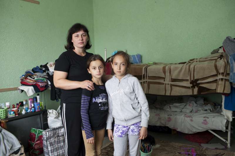 A Ukrainian mother poses with her daughter and a young friend in the room where she lives with her family in a centre for displaced people in Slavyansk. Most of the people are from the Luhansk and Donetsk regions. © UNHCR/E.Ziyatdinova