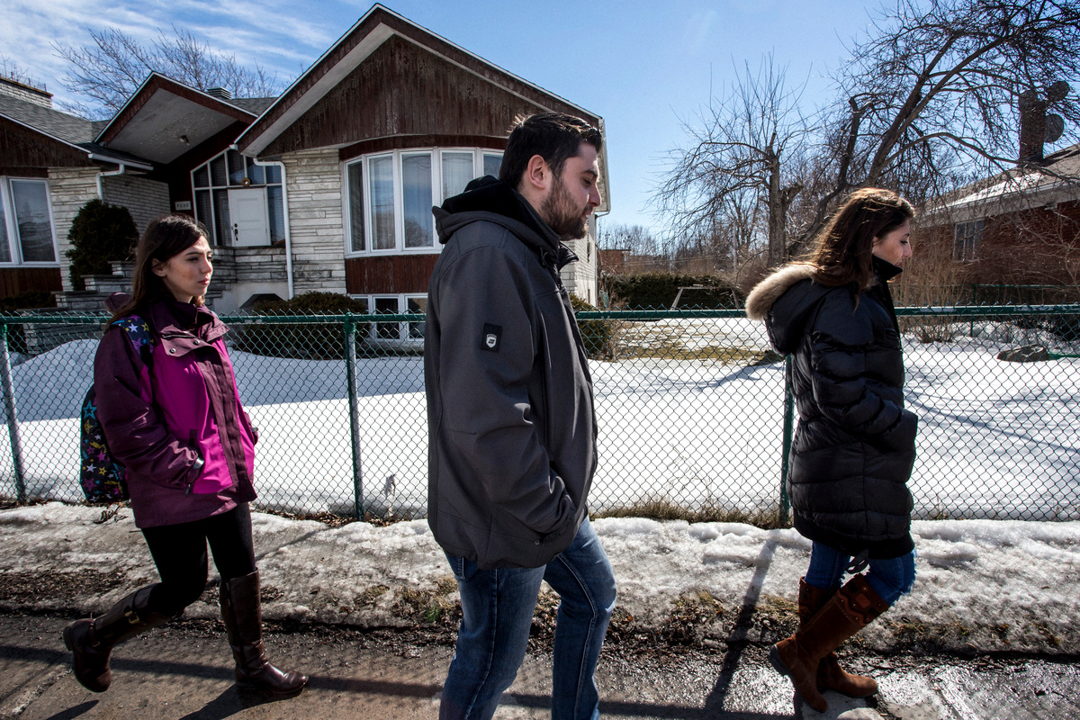 Canada. Refugees walk down the streets of Laval