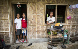 Merlyn Mandak (left) at home in Kidapawan with her youngest daughter, Mary Che, and husband Joseph. They are among more than 6,000 people of Indonesian descent in the southern Philippines.