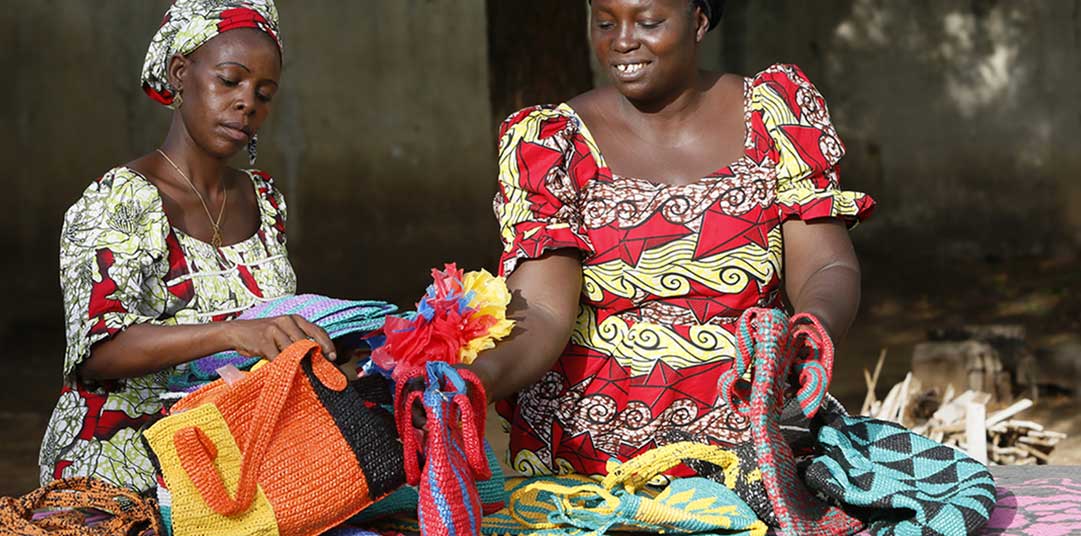 Kwatina and Laity show the bags they have made from recycled materials  