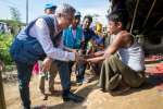 High Commissioner Filippo Grandi talks to a young Rohingya man at Kutu...