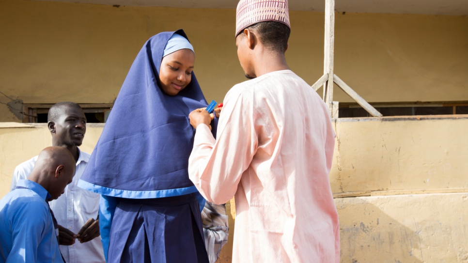 Zeinab Ibrahim, 16, is named prefect at morning assembly at Treasures Richfield College, the secondary school she can attend thanks to Mustapha.