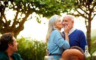 An elderly couple kissing