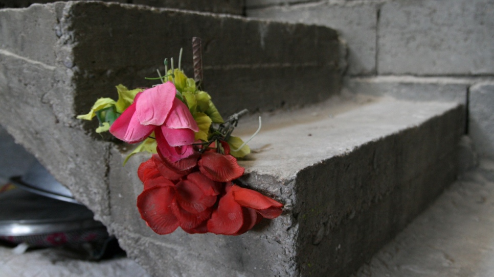 The family have tried to decorate their sparse and damaged house to make it more cheerful.