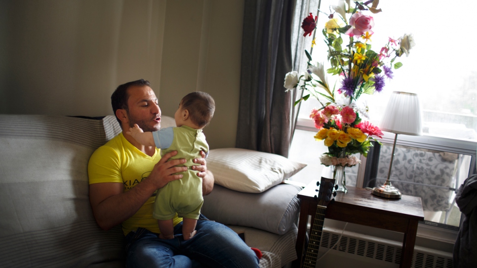 Mohammed with his son Tajaldeen in their new home in Ottawa, Canada.