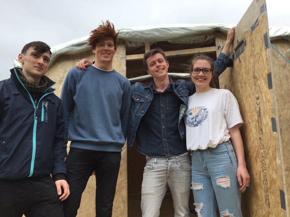 University College Cork civil engineering students show off a shelter with a raised platform that they designed and built
