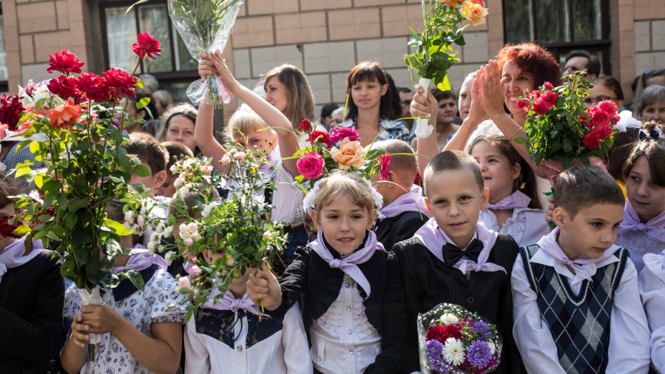 The children attend an official ceremony marking the start of the school year.