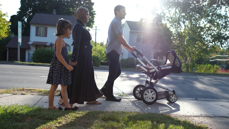 The Eshadi family walk to Tanna and Joe's house, two blocks from their home in Peterborough.