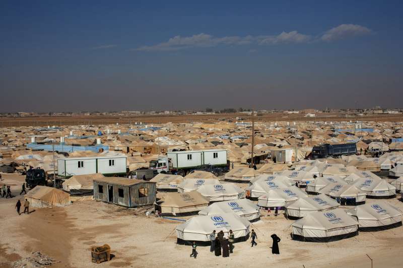 Trucks pull pre-fabricated homes through the centre of Zaatari camp. UNHCR relocated about 2,000 refugee families to these homes, which provide better protection and insulation in winter