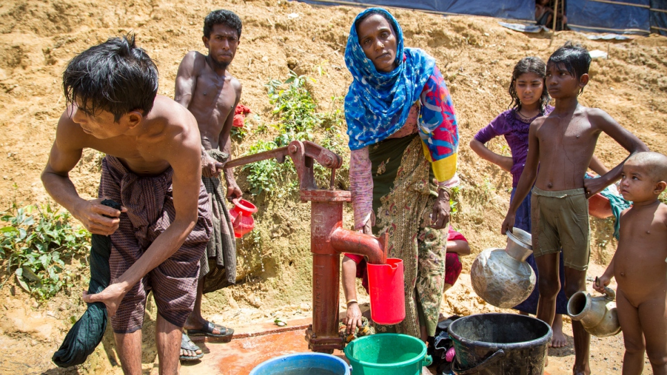 Khaleda Begum, 25, pulls water from the well in Kutupalong refugee camp extension.