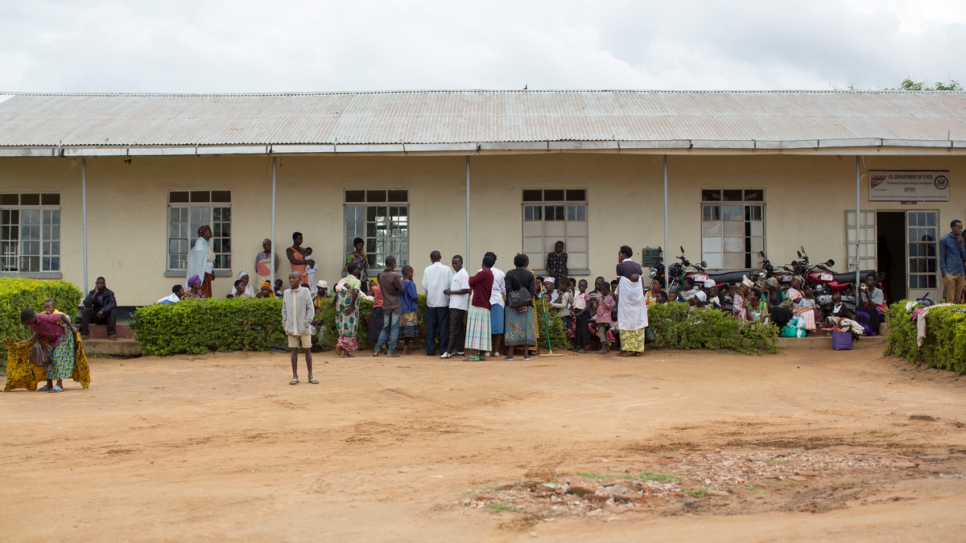 Refugees and locals gather outside the health centre at Nakivale settlement.
