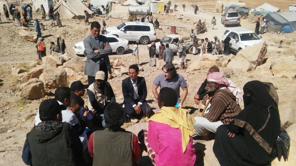 Adem Shaqiri (centre, blue check shirt) negotiates with landowners and authorities to ensure immediate access to deliver aid to 300 displaced families at an informal settlement in Khamir, Yemen, in February 2017.
