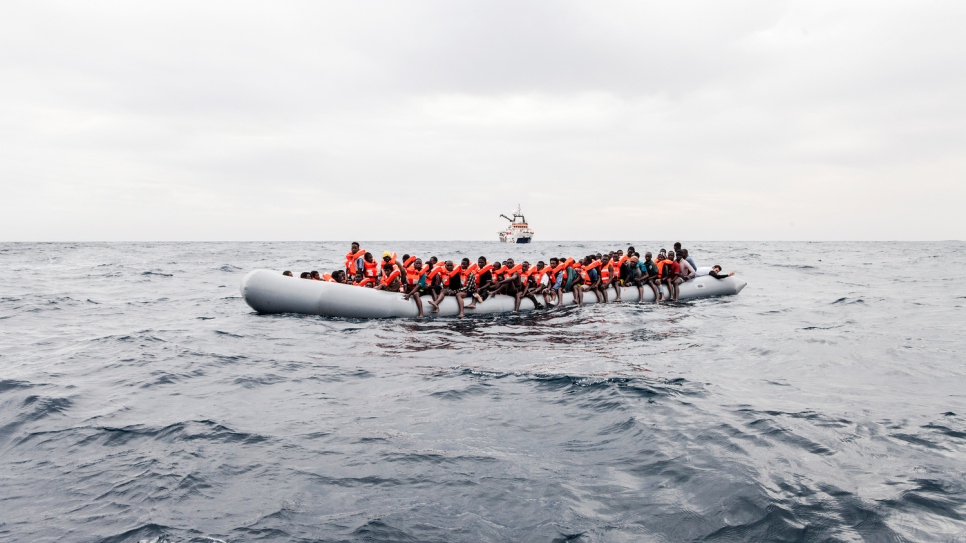 Asylum-seekers and migrants aboard a dinghy spotted by the MOAS crew in international waters off the coast of Libya.
