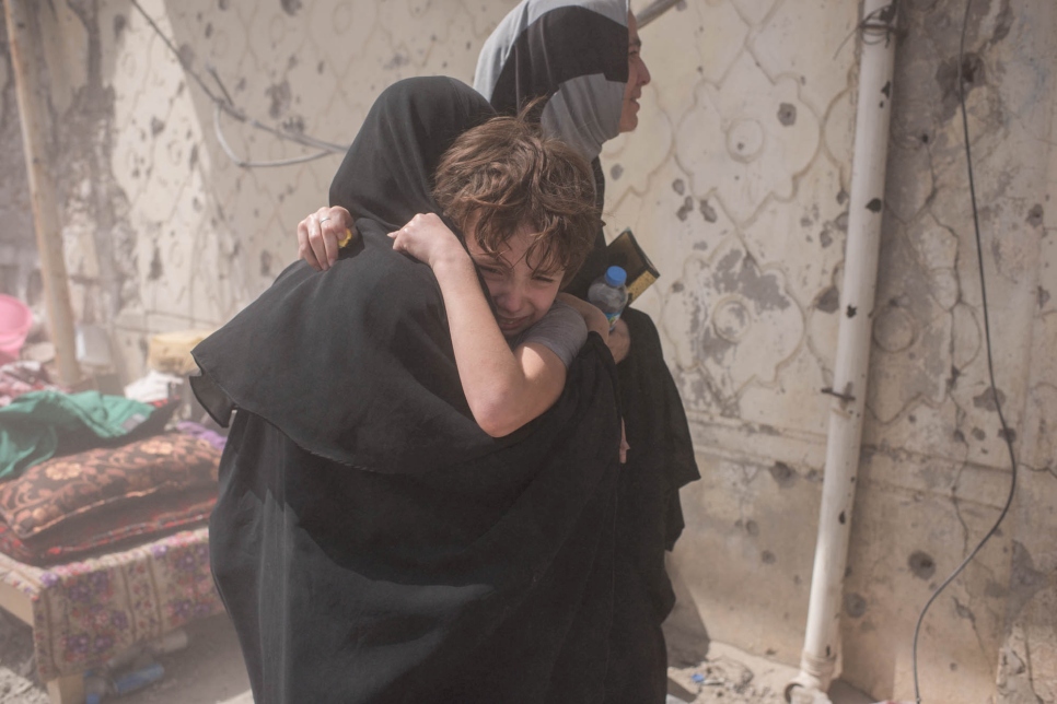 A mother and son embrace after being separated while fleeing fighting in the Old City of Mosul on June 24, 2017.