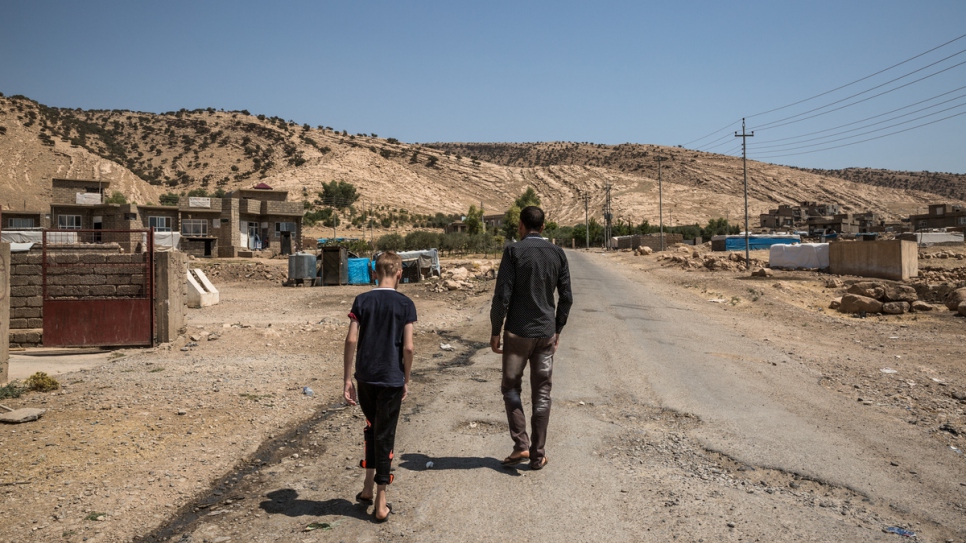 Hadi et son neveu Emad se promènent dans le village où ils sont logés, à Dohouk, dans la région du Kurdistan d'Iraq.