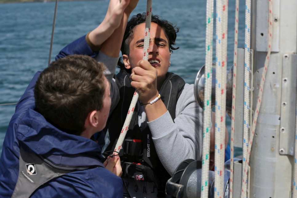 Adnan, un demandeur d'asile syrien, et Diarmaid, un Irlandais, hissent la grand-voile.