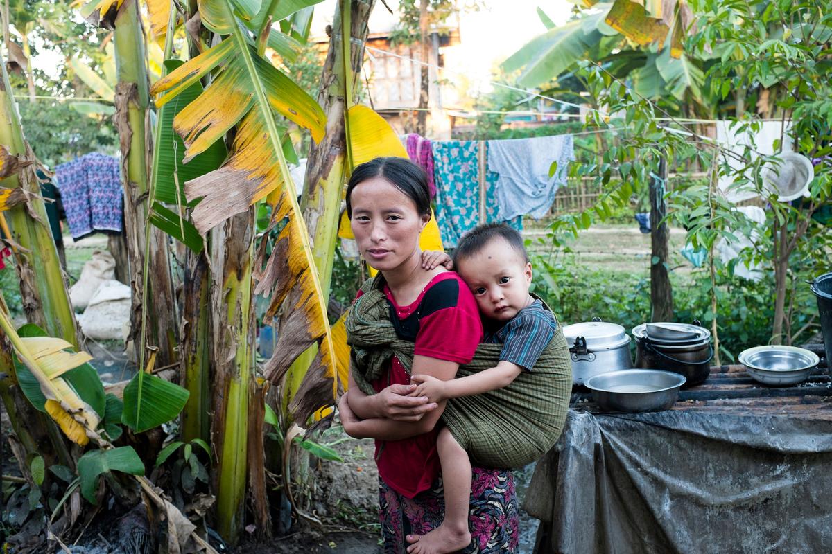 A mother cradles her child inside a camp for internally displaced people in Kachin State, Myanmar, in November 2013.