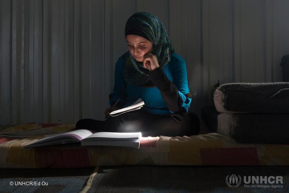 Muzon studies in her home at Azraq camp.