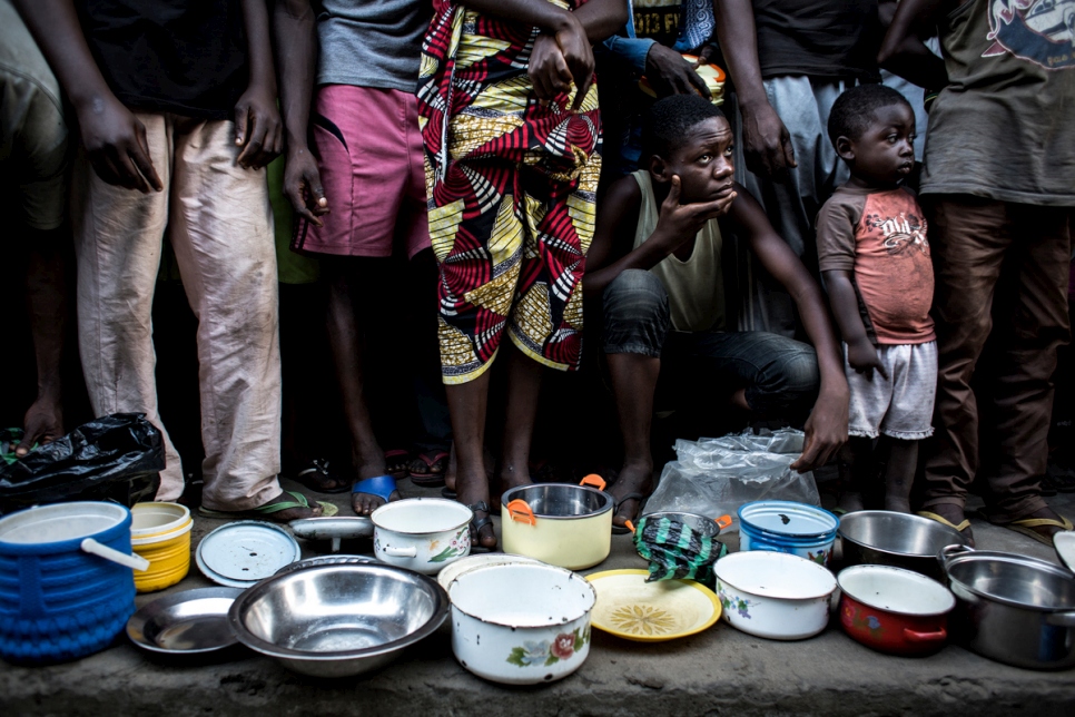 Internally displaced Congolese families from Kasai province wait in line for food in the grounds of a former clinic in the town of Idiofa, Democratic Republic of the Congo.