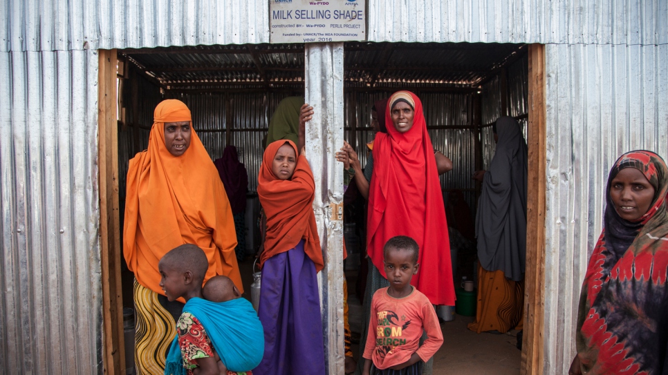 Somali refugee women stand outside the dairy cooperative after a long day. "We are 20 women who have created a cooperative to sell milk and become self-reliant. We sell milk to refugees and the host community, and generate income to sustain our families."