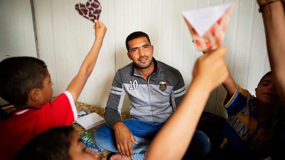 Fadi works as a classroom assistant at a community centre funded by UNHCR.