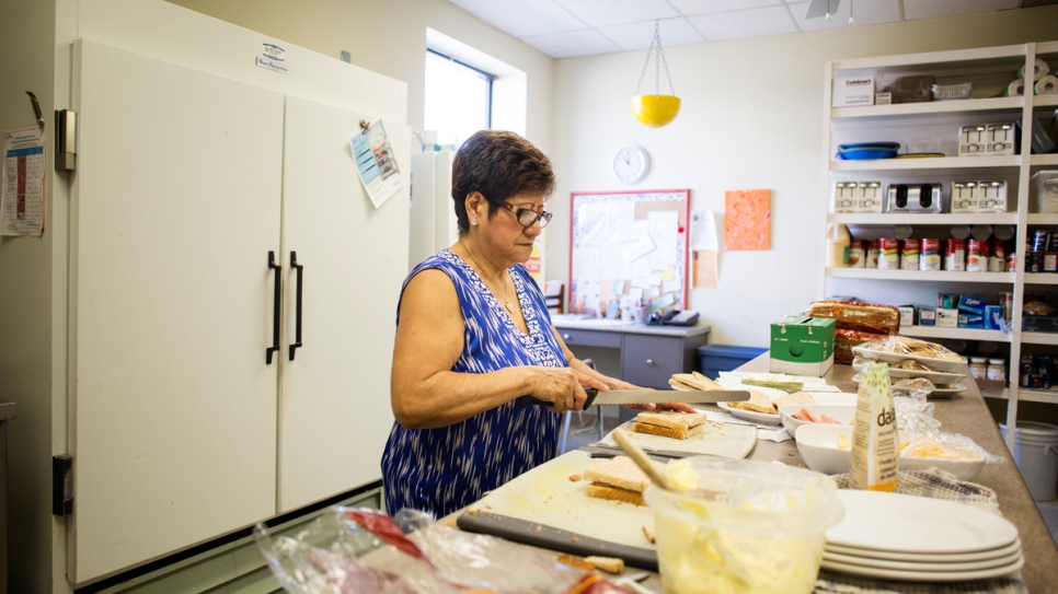 Gladys prepares food for children at the daycare center.