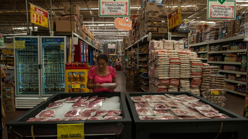 Margarita shops for groceries in a local supermarket.