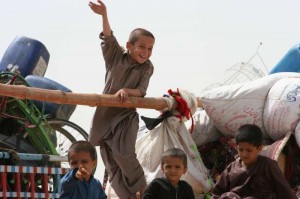 Young Afghan refugees on their way home to Afghanistan wave goodbye to Pakistan. © UNHCR/B.Baloch