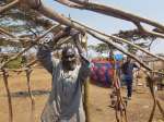 Congolese refugee Chipile erects a makeshift shelter in the sweltering...