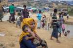 Rohingya mother Zulkhair, 27, holds her 10-month-old son Mohammad, at ...