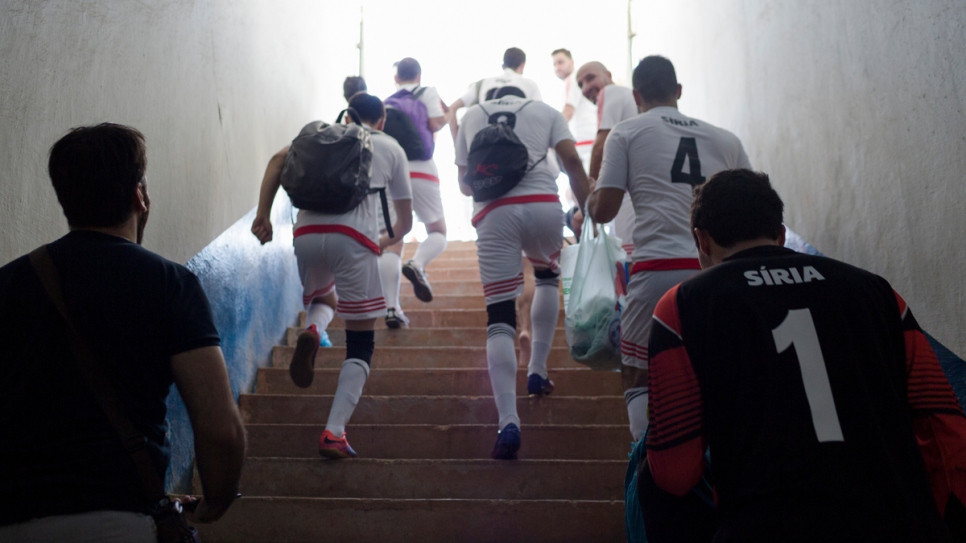 Syrian players run on to the pitch at the Refugees World Cup in CERET Park, Sao Paulo, Brazil.