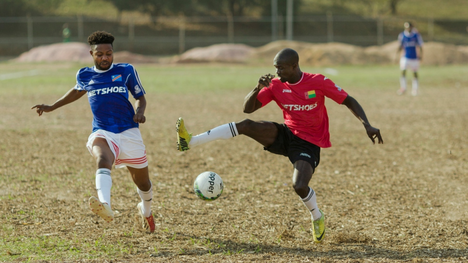 The Democratic Republic of Congo (in blue) and Guinea-Bissau (in red) compete in the first round of the Refugees World Cup in CERET Park, Sao Paulo, Brazil.