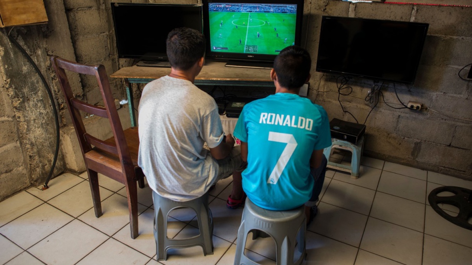 Moises and Anderson play a video game at a local store.