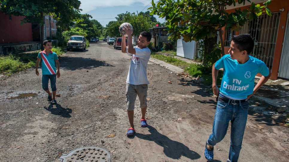 Moises, Anderson and Jairo walk through the streets of their neighbourhood.