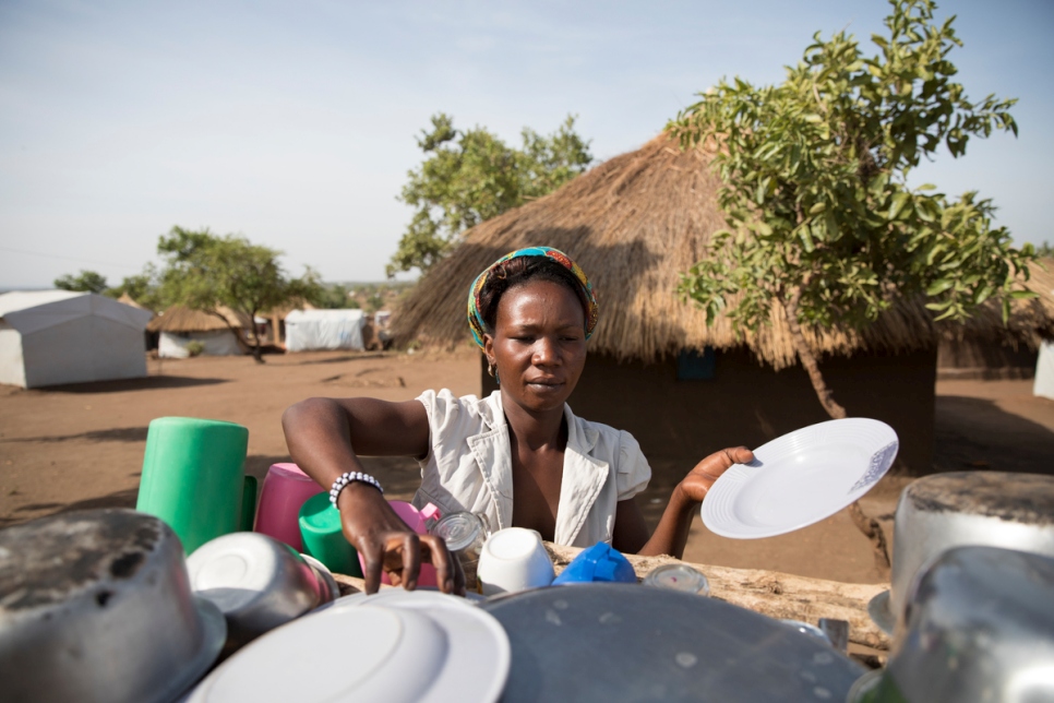 South Sudanese refugee Aisha, 29, looks after five children in Bidibidi refugee settlement. She and the children arrived in Uganda with next to nothing. They received a UNHCR emergency shelter and Aisha set about building a more permanent home from mud bricks she made herself and a thatched roof using grass she collected from the bush. 