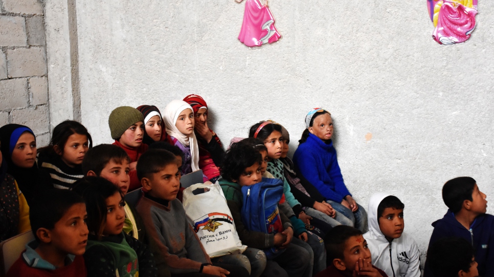 Wafaa, in blue, sits with her classmates, who have all been displaced by six years of war in Syria.