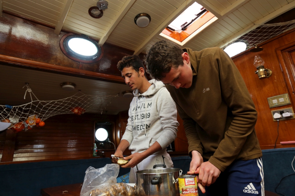 Zaher, an asylum-seeker from Syria, and Diarmaid from Ireland, prepare dinner.
