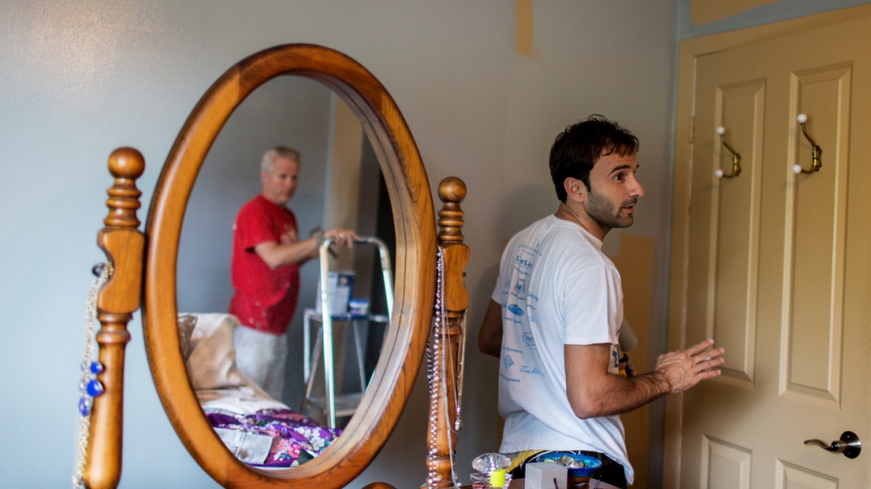 Dave, a local volunteer, hired Husam to work part-time as a painter.