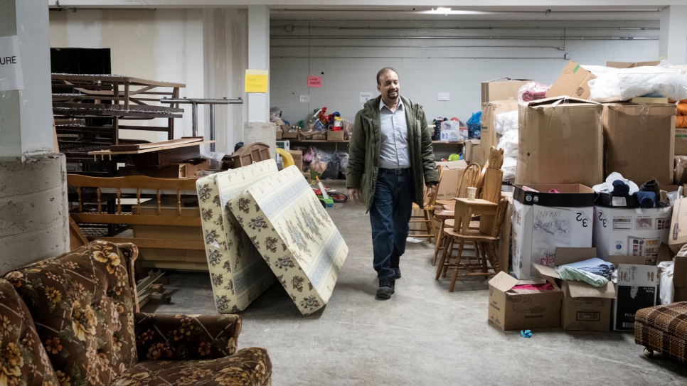 Muhammed Sayyed, president of the Muslim Society of Guelph, walks through the warehouse space used by volunteers helping to resettle Syrian refugees.