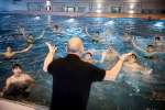 Local volunteer Heino Rahmstorf leads a swimming session for asylum-seekers from Syria, Iraq and Afghanistan at the swimming pool in Neu Wulmstorf, Germany.