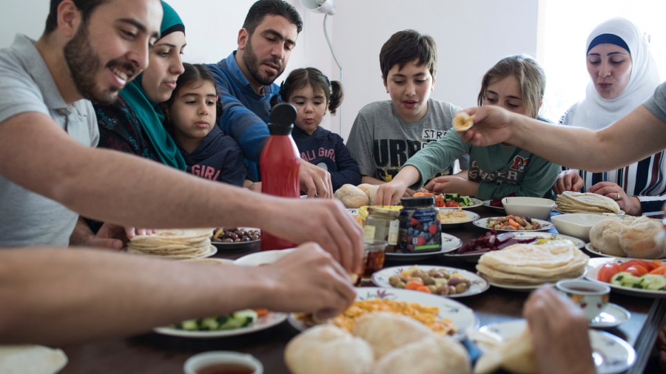 The Dabah family, who fled war in Syria in 2012, eat breakfast at their home in Lisbon, Portugal. 