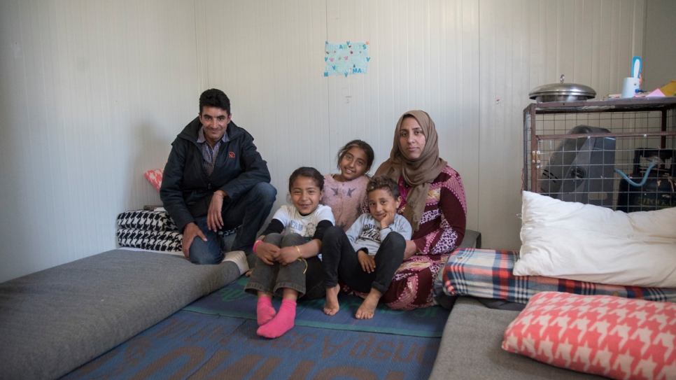 A Syrian family inside their prefabricated container installed by UNHCR at Kara Tepe, in Lesvos, Greece. Over 5,000 refugees and migrants have found shelter in 1,000 prefabricated houses installed by UNHCR across Greece.