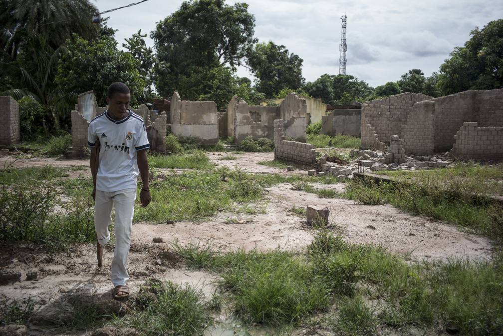 A young man walks in Fondo, one of the neighbourhoods in the PK5 enclave in Bangui, which was severely affected by the fighting in 2013 and 2014. Following the recent improvement of the security situation in 2015, people has started to go back to their homes. With the violence that erupted on Saturday, PK5 became deserted again, with people fleeing in the bush or to IDP camps. ©UNHCR/Olivier Laban-Mattei