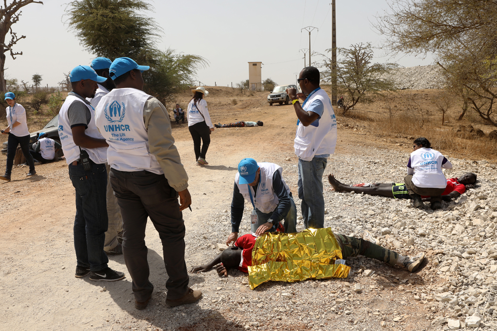 A car accident simulation with several wounded people. Participants are expected to provide first aid assistance, stabilize the wounded and contact medical agencies and structures for immediate help. © UNHCR / Helene Caux
