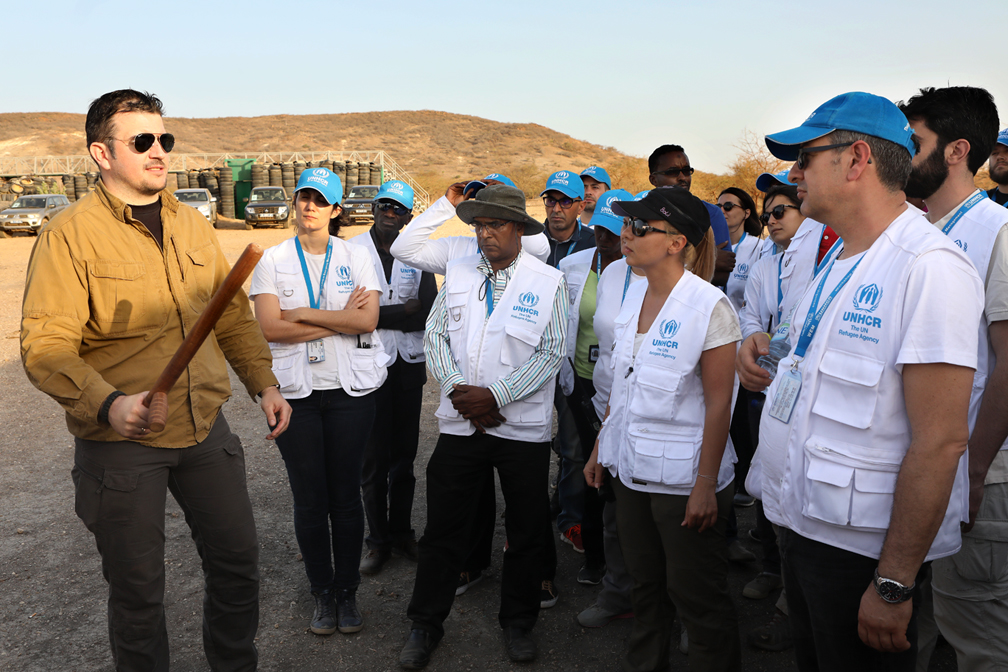 A UNHCR Security trainer explains and shows to the WEM participants the dangers they could face if trapped in a crowd once deployed in emergencies in the field. © UNHCR / Helene Caux