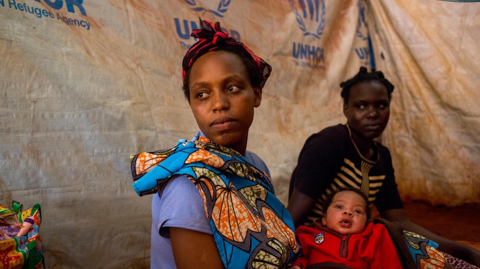 Sandrine in the emergency shelter with baby Promence and friend Aline.