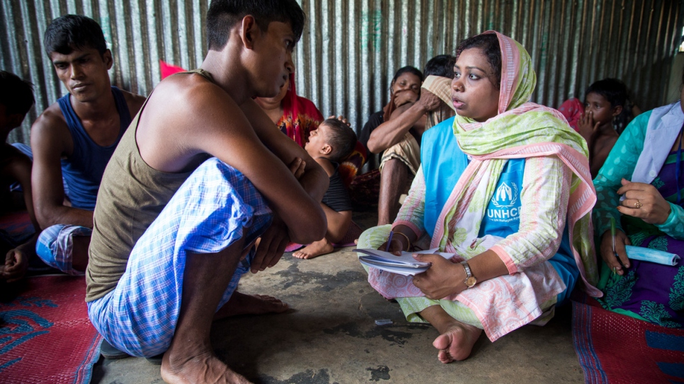 Mahmuda talks with Nurus Salam, 22, a Rohingya boat wreck survivor who lost relatives when their boat capsized on Inani Beach near Cox's Bazar, Bangladesh.