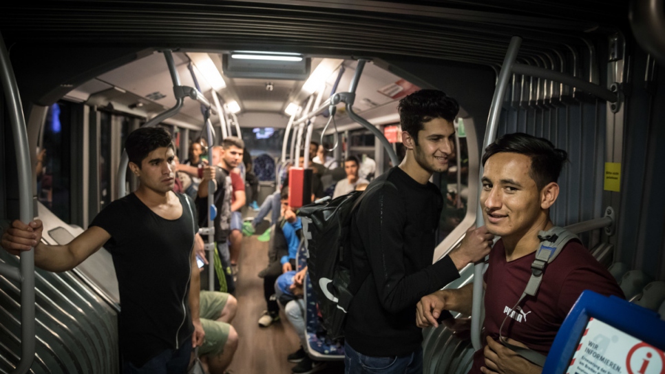 Farooq (right) with friends on the tram following a training session.